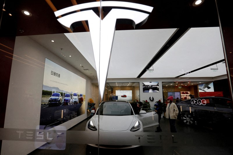 Tesla shares jump to record high